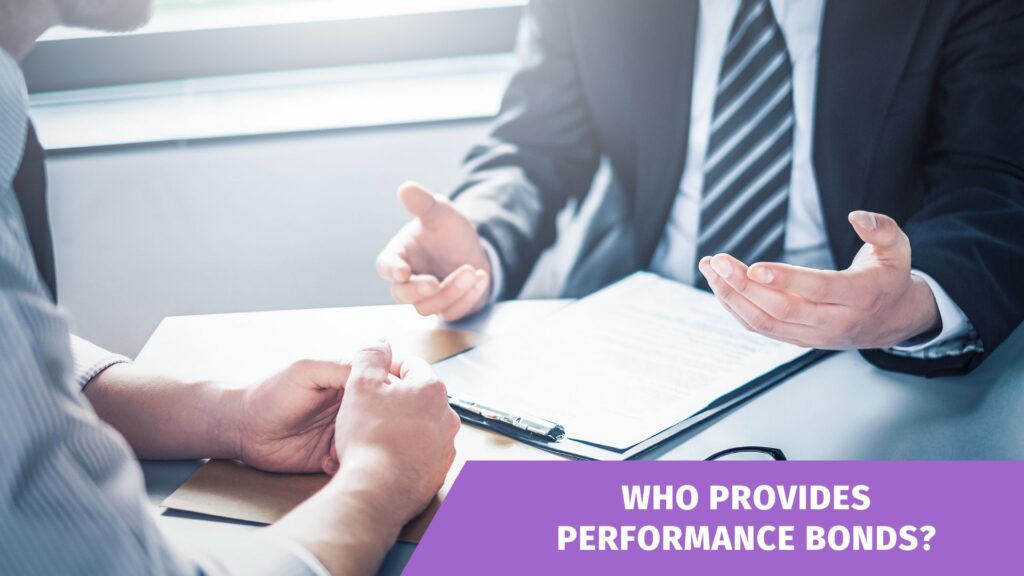 Who provides Performance Bonds - An agent is talking to a businessman about the contract at the table inside the office of a surety company.